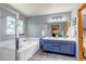 Bright bathroom features a double sink vanity, soaking tub, and separate shower at 2996 Savage Rd, Elizabeth, CO 80107