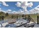 Outdoor dining area with a glass table and wrought iron chairs overlooks a large field at 2996 Savage Rd, Elizabeth, CO 80107
