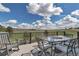 Outdoor deck with patio furniture, ideal for outdoor dining while overlooking lush green fields at 2996 Savage Rd, Elizabeth, CO 80107