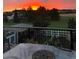 Outdoor deck with seating offers stunning views of the backyard, mature trees, and sunset at 2996 Savage Rd, Elizabeth, CO 80107