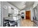 Bright kitchen features white cabinetry, stainless steel appliances, granite countertops, and a vaulted ceiling at 2996 Savage Rd, Elizabeth, CO 80107