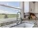 Close-up of kitchen sink with view to the meadow through the window at 2996 Savage Rd, Elizabeth, CO 80107