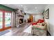Cozy living room with a stone fireplace, wood floors, and French doors leading to the outdoors at 2996 Savage Rd, Elizabeth, CO 80107