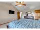 Spacious main bedroom with vaulted ceiling, ceiling fan, modern art, and a large window at 2996 Savage Rd, Elizabeth, CO 80107