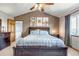 Spacious main bedroom with vaulted ceiling, ceiling fan, modern art, and a large window at 2996 Savage Rd, Elizabeth, CO 80107