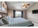 Spacious main bedroom with vaulted ceiling, ceiling fan, modern art, and a large window at 2996 Savage Rd, Elizabeth, CO 80107