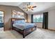 Spacious main bedroom with vaulted ceiling, ceiling fan, modern art, and a large window at 2996 Savage Rd, Elizabeth, CO 80107