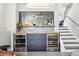 Stylish bar area featuring dual wine fridges, blue cabinets, and a unique hexagonal tile backsplash at 1292 W 133Rd Cir, Westminster, CO 80234