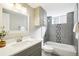 Bright bathroom with modern vanity, gray tile shower, and updated fixtures at 1292 W 133Rd Cir, Westminster, CO 80234