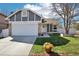 Charming home featuring a two-car garage, well-manicured lawn, and appealing landscaping at 1292 W 133Rd Cir, Westminster, CO 80234