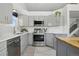 Updated kitchen with stainless steel appliances, gray cabinets, and ample counter space at 1292 W 133Rd Cir, Westminster, CO 80234