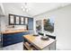 Charming dining area with navy cabinets, breakfast bar, and access to the back deck at 1292 W 133Rd Cir, Westminster, CO 80234