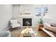 Sun-drenched living room featuring a modern fireplace, stylish decor, and comfortable seating at 1292 W 133Rd Cir, Westminster, CO 80234