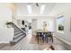 Bright living space with a modern open staircase and view into a stylish, updated kitchen at 1292 W 133Rd Cir, Westminster, CO 80234