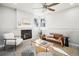 Cozy living room featuring a decorative fireplace, ceiling fan, and lots of natural light at 1292 W 133Rd Cir, Westminster, CO 80234