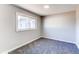 Bright bedroom with window and access to hallway at 7780 Hollywood St, Commerce City, CO 80022