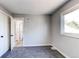 Well-lit bedroom with grey carpet and access to bath at 7780 Hollywood St, Commerce City, CO 80022