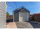 Gray detached garage with a white door at 7780 Hollywood St, Commerce City, CO 80022