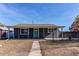 Newly renovated gray house with green door and covered porch at 7780 Hollywood St, Commerce City, CO 80022