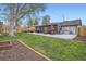 Large backyard with patio, outdoor seating, a lush lawn, and space for outdoor activities and relaxation at 1655 S Lowell Blvd, Denver, CO 80219