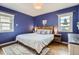 Comfortable bedroom features wood flooring, cozy rug, and two bedside tables at 1655 S Lowell Blvd, Denver, CO 80219