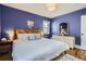 Serene bedroom with a wood headboard, soft lighting, and hardwood floors at 1655 S Lowell Blvd, Denver, CO 80219