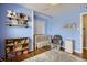 Cozy Bedroom featuring hardwood floors, natural light, and a comfortable rocking chair at 1655 S Lowell Blvd, Denver, CO 80219