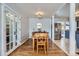 Bright dining room features hardwood floors, a modern chandelier, and stainless steel refrigerator at 1655 S Lowell Blvd, Denver, CO 80219