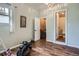 Bright flex space with wood floors features closet, bathroom and workout equipment for convenience at 1655 S Lowell Blvd, Denver, CO 80219