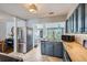 Modern kitchen features updated appliances, stylish countertops, and chevron-patterned wood floors at 1655 S Lowell Blvd, Denver, CO 80219