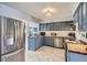 Beautiful kitchen with blue cabinets, butcher block countertops and stainless steel appliances at 1655 S Lowell Blvd, Denver, CO 80219