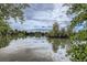 Calm lake reflecting the sky, surrounded by trees, offering a serene and peaceful view at 1655 S Lowell Blvd, Denver, CO 80219