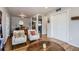 Open-concept space reveals a dining area and a living room with hardwood floors at 1655 S Lowell Blvd, Denver, CO 80219