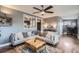Comfortable living room boasts a modern ceiling fan and an open design to the office area at 1655 S Lowell Blvd, Denver, CO 80219