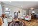Spacious living room with hardwood floors, built-in window seat, and access to the dining area at 1655 S Lowell Blvd, Denver, CO 80219