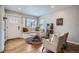 Cozy living room featuring hardwood floors, a bay window with built-in seating, and comfortable furnishings at 1655 S Lowell Blvd, Denver, CO 80219
