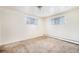 Bright bedroom with neutral walls and carpet at 4730 Carr St, Wheat Ridge, CO 80033