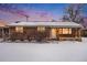 Brick ranch house with snowy front yard at 4730 Carr St, Wheat Ridge, CO 80033