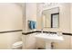 Bathroom featuring a pedestal sink, a bright mirror, and classic fixtures at 12963 Silver Elk Ln, Littleton, CO 80127