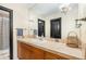 Well-lit bathroom featuring a functional vanity area, decorative tiling, and convenient amenities at 12963 Silver Elk Ln, Littleton, CO 80127