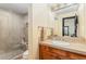 Bathroom featuring a glass shower, single vanity with a wood cabinet, and travertine countertops at 12963 Silver Elk Ln, Littleton, CO 80127
