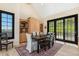 Bright dining area with natural light, stylish rug, and views to the outside at 12963 Silver Elk Ln, Littleton, CO 80127