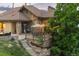 Stunning exterior view of the home with a stone facade, and outdoor entertaining area at 12963 Silver Elk Ln, Littleton, CO 80127
