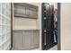 Hallway with custom gray built-in cabinets and a door opening into a walk-in closet at 12963 Silver Elk Ln, Littleton, CO 80127