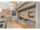 Well-appointed kitchen featuring custom cabinets, granite counters, and a unique brick cooking fireplace at 12963 Silver Elk Ln, Littleton, CO 80127
