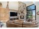 Comfortable living room with a stone fireplace, and a large sectional couch perfect for relaxing at 12963 Silver Elk Ln, Littleton, CO 80127