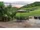 Outdoor stone patio has dining area and stone seating, backing up to green mountainside at 12963 Silver Elk Ln, Littleton, CO 80127