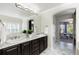 The bathroom features a double sink vanity with granite counters, a large mirror, and modern fixtures at 16376 Stonefeld Pl, Parker, CO 80134
