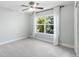 Bright bedroom featuring large window with backyard view and neutral colored walls at 16376 Stonefeld Pl, Parker, CO 80134