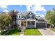 Beautiful two-story home featuring a landscaped front yard, inviting porch, and attached two-car garage at 16376 Stonefeld Pl, Parker, CO 80134
